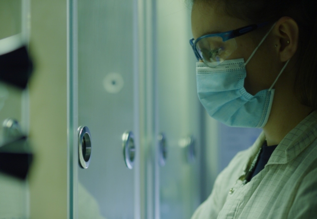Woman wearing a mask working in the lab
