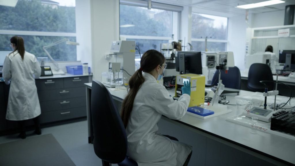 Researcher seated in a formulation lab