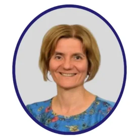 Smiling professional with chin-length light brown hair and a blue floral top, framed in a navy oval border on a light gray background