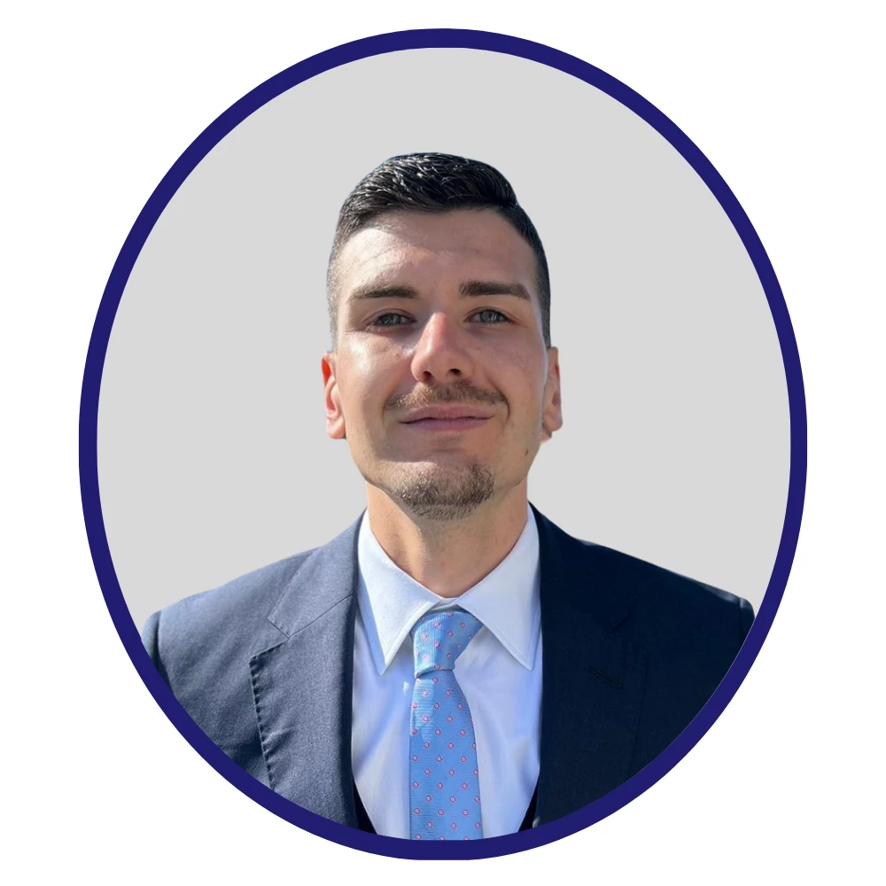 Professional headshot of Pharmaron team member Javier Ruiz Sanz in a dark suit and patterned blue tie