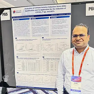 Scientist presenting a Pharmaron poster on CYP3A4 relative induction score and its application for induction of CYP2Cs, P-gp, and UGTs at a conference.