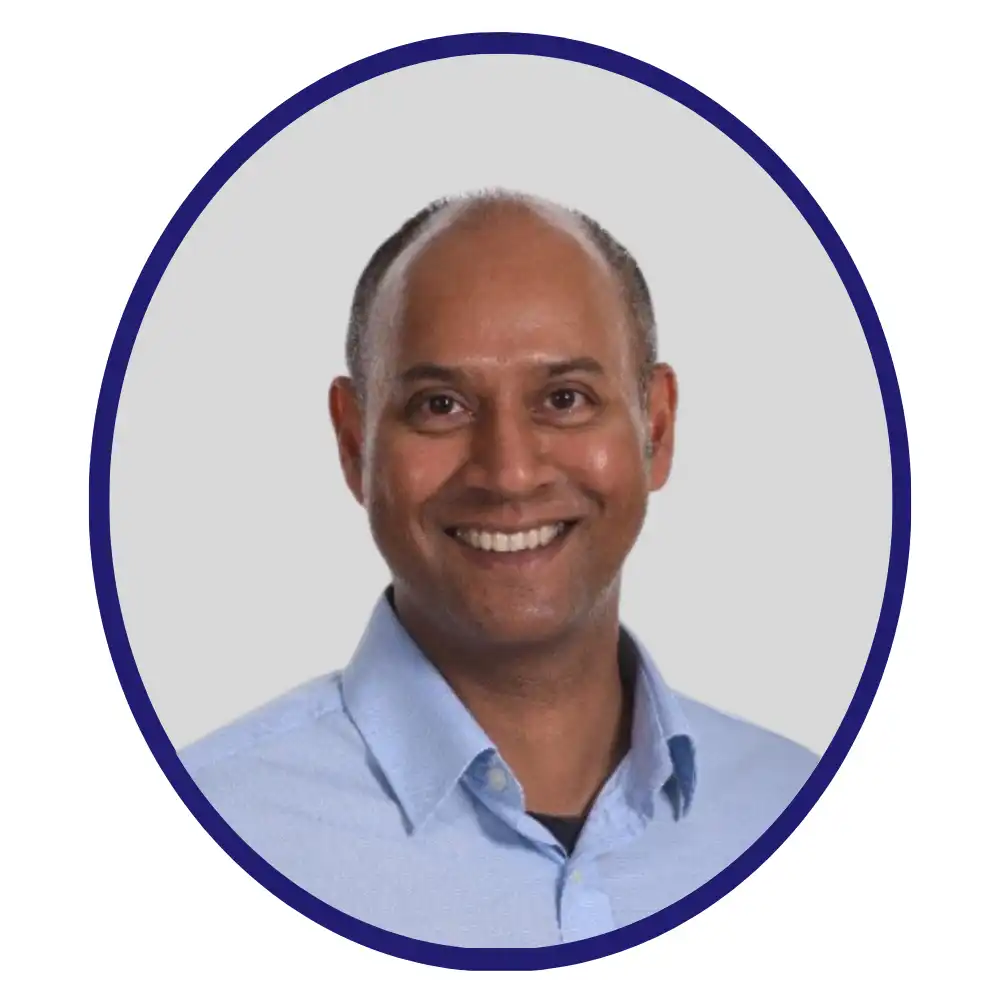 Pharmaron scientist Adrian Pereira, professional headshot with navy oval frame and light blue shirt