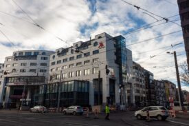 Exterior of the Basel Marriott Hotel and Congress Center with Welcome to Basel banner, host venue for BOS Basel 2026