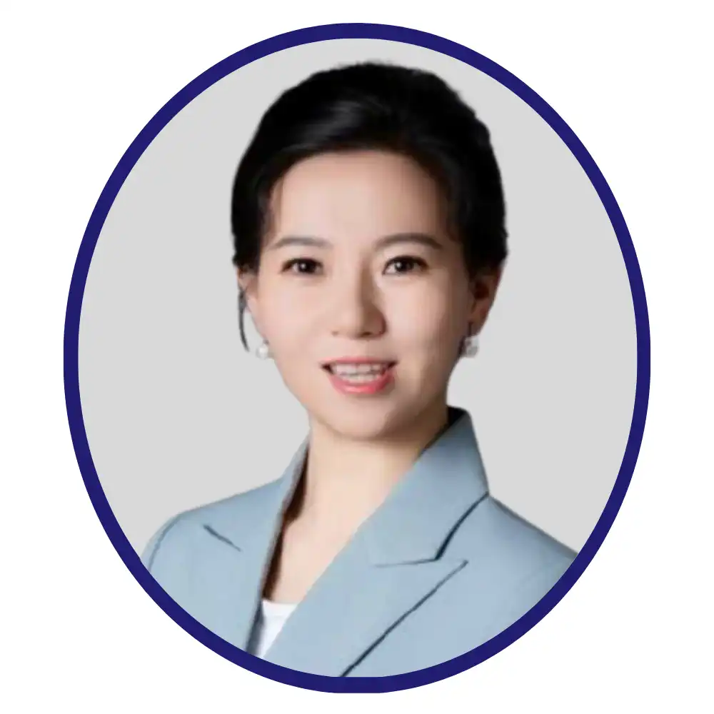 Danxi Li professional headshot, wearing a light blue blazer, in a navy oval frame on a grey background