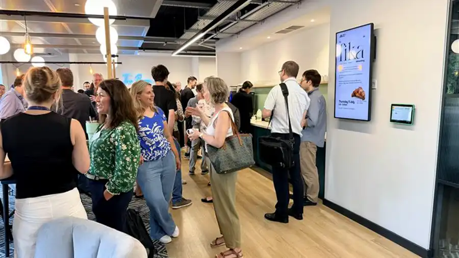 Scientists networking over refreshments at the 2026 Oxford Lunch and Learn reception in a modern office space