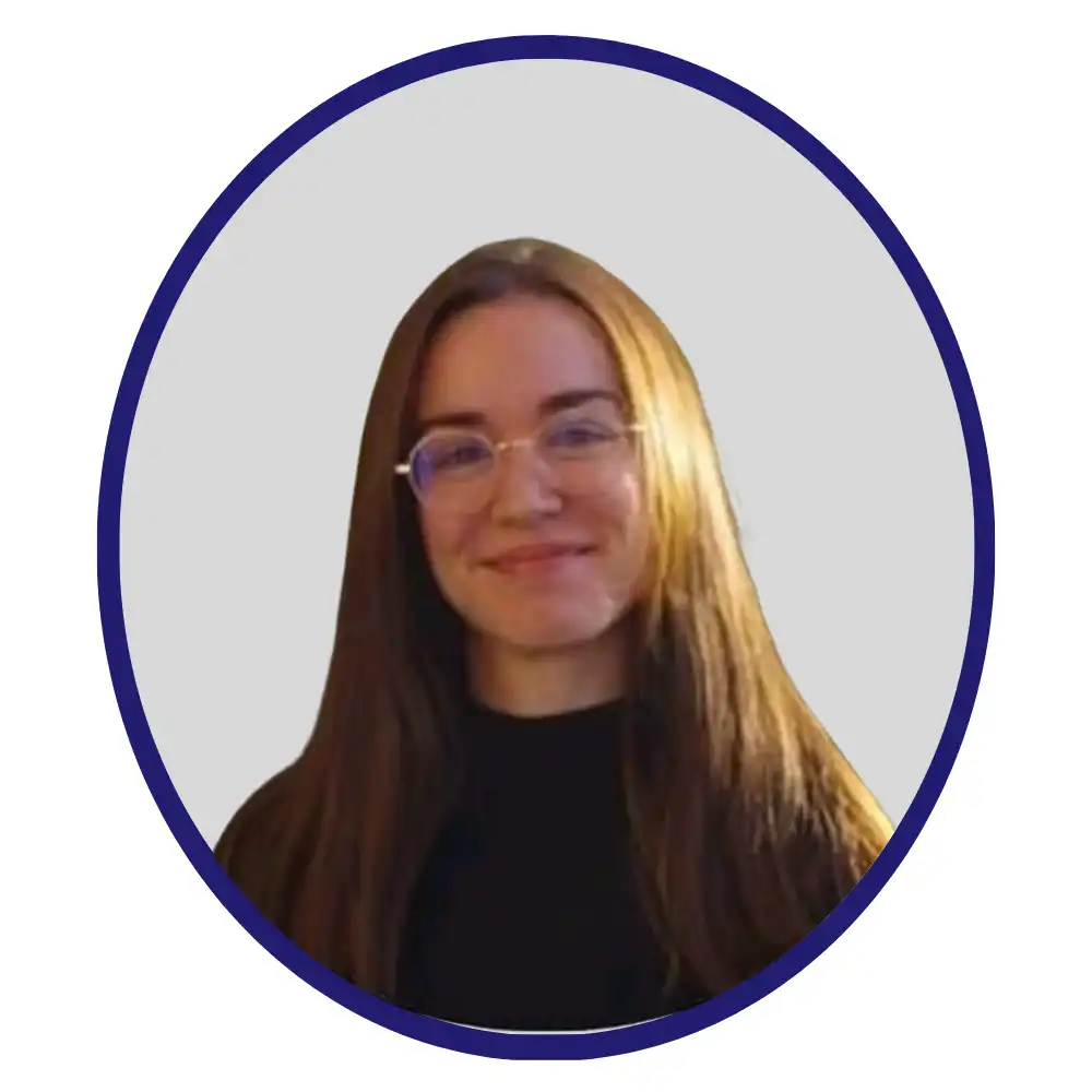 Smiling biopharma professional with long brown hair and round wire-framed glasses in a black top, navy oval-framed headshot on gray background