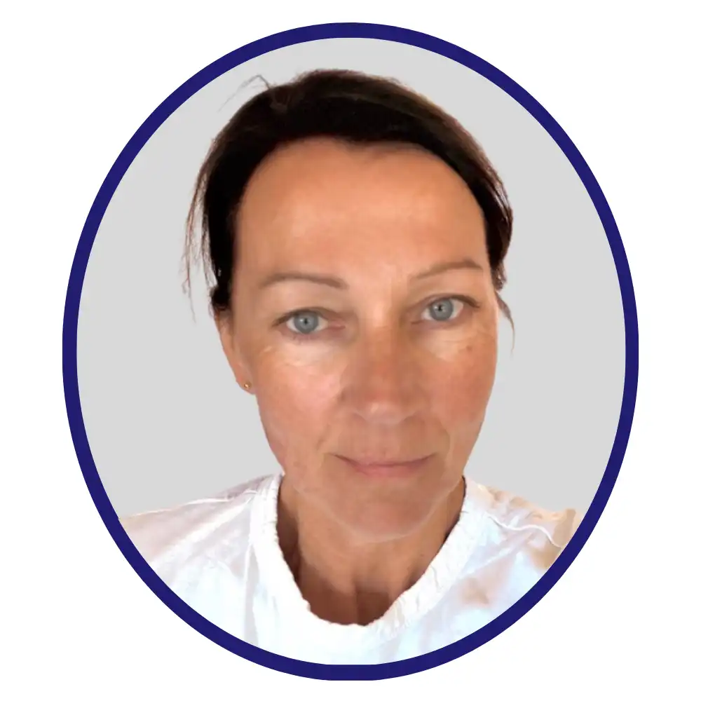 Professional with dark brown hair pulled back and a white crew-neck top, framed in a navy oval on a light gray background
